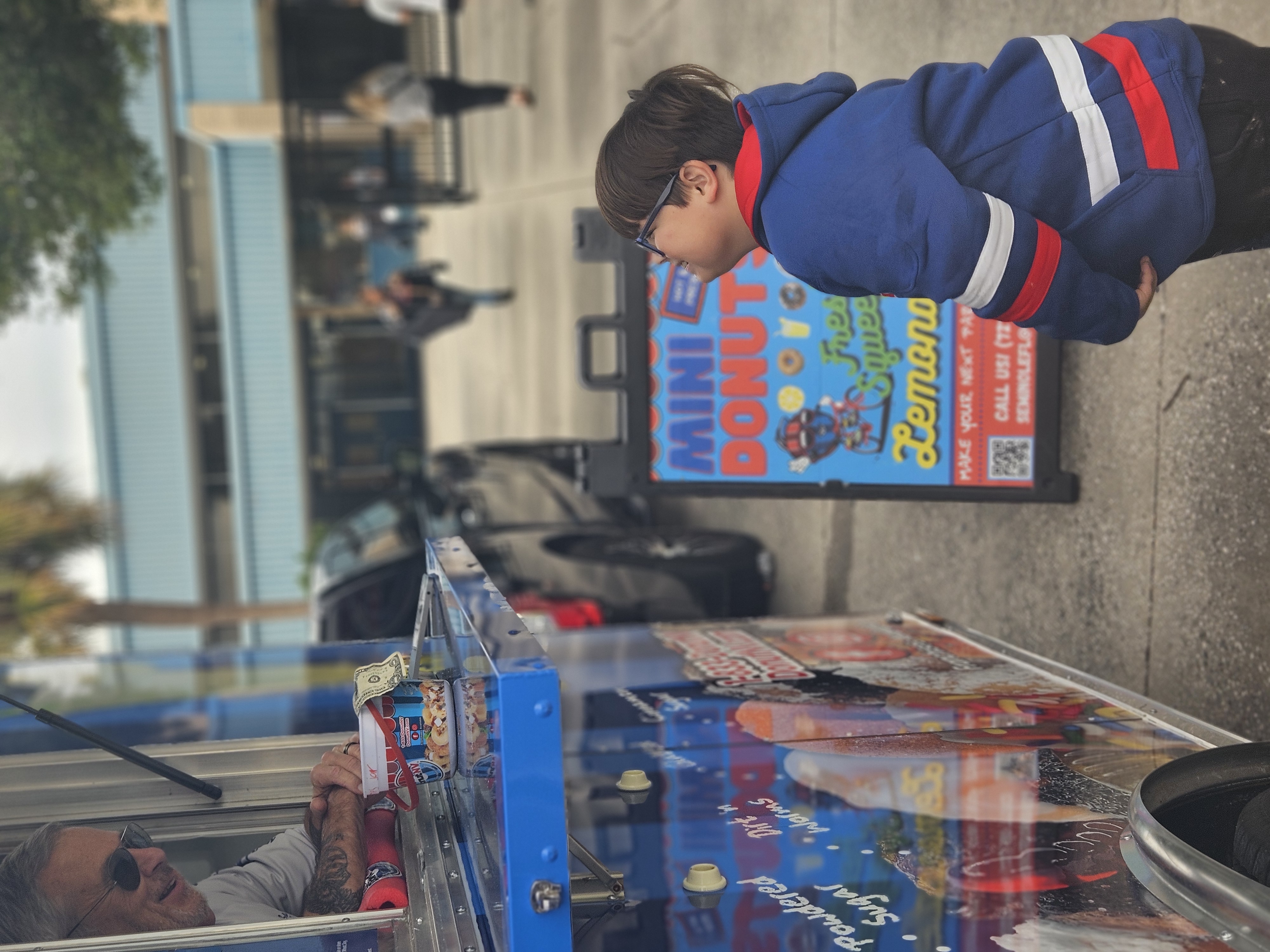 Child in awe watching donuts being made at DonutNV