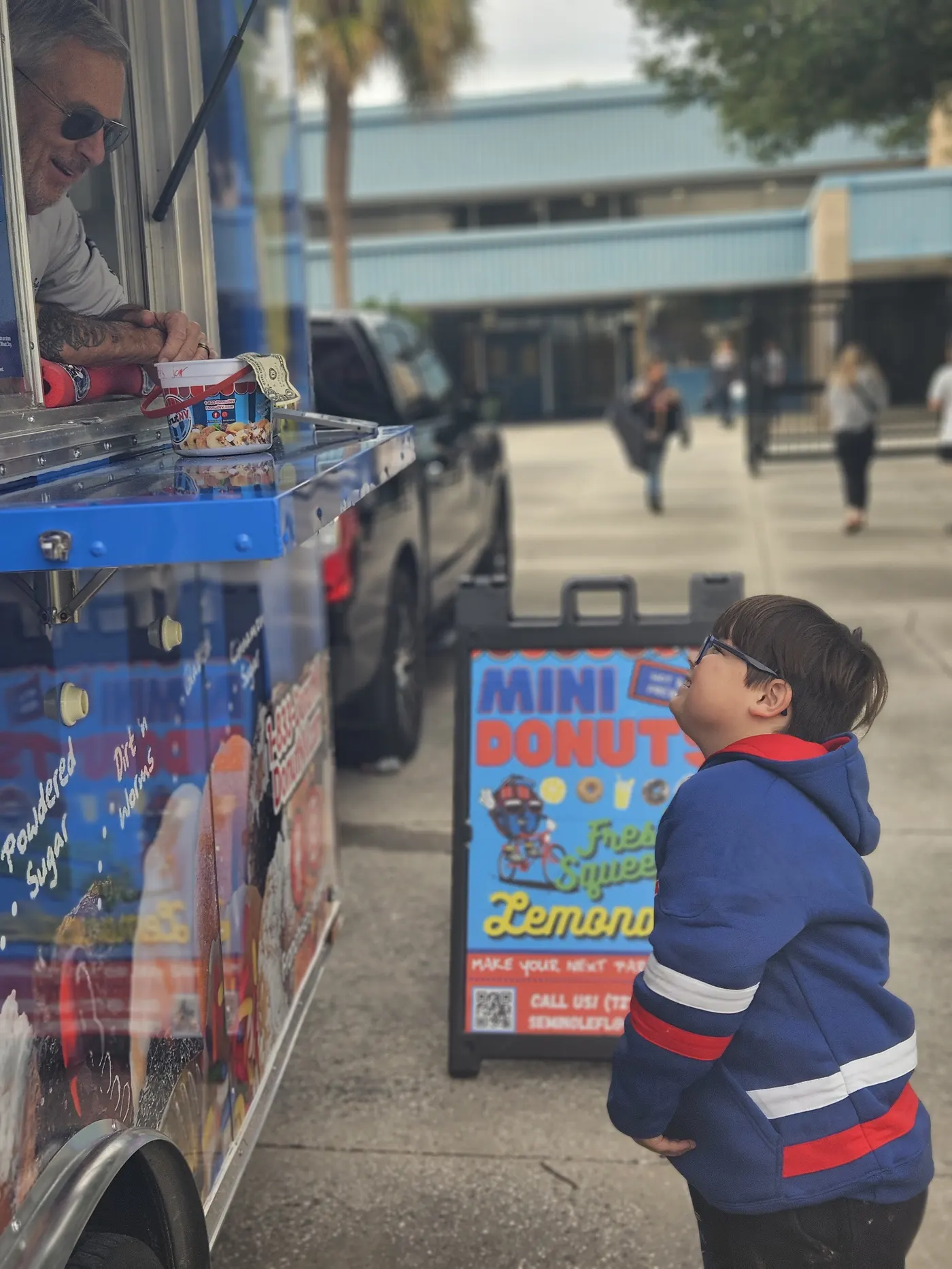 Child in awe watching donuts being made at DonutNV