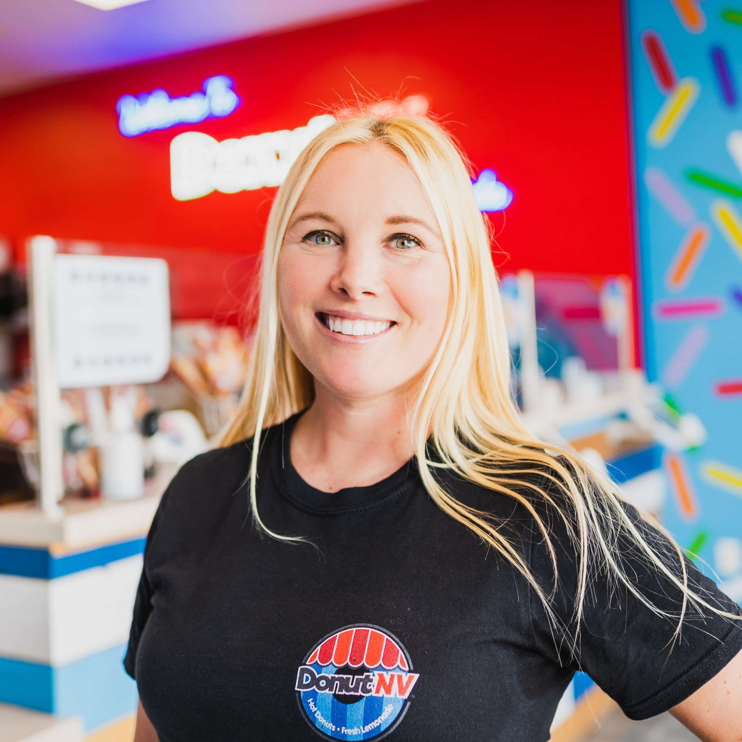 Picture of Amanda Gingold, cofounder of DonutNV smiling in one of her donut shops.
